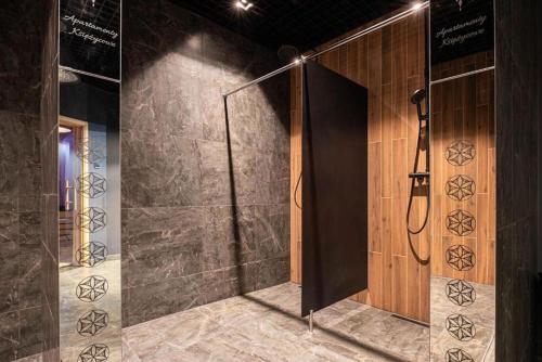a shower stall in a room with a wall at Golden Apartments - Tatra View - Księżycowe Apartamenty SPA - 24d-1 in Zakopane