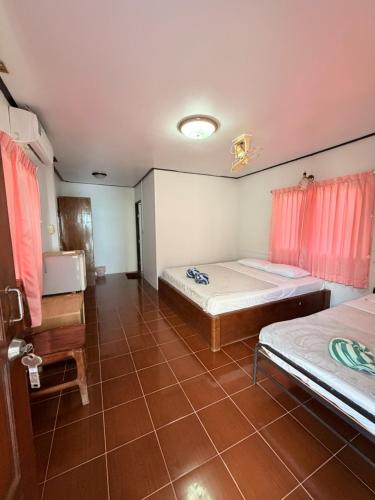 a room with two beds and a window in it at Paradise Bungalows Lamai Beach in Lamai
