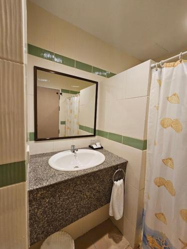a bathroom with a sink and a mirror at Baan Suksiri Hotel Hua Hin in Hua Hin
