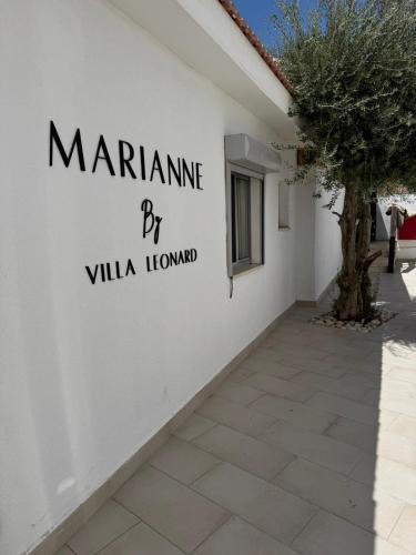 a white wall with the words mariana by villa loma at Merian Eilat in Eilat