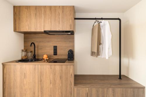 a kitchen with a wooden counter with a sink at PortoVista Luxury Urban Suites by BiNoBi! in Thessaloniki