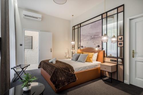 a bedroom with a king sized bed with an orange headboard at Budapest Cereja Boutique in Budapest