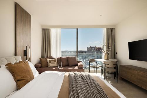 a bedroom with a bed and a living room at PortoVista Luxury Urban Suites by BiNoBi! in Thessaloniki
