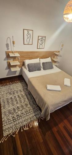 a bedroom with a bed with two pillows and a rug at URA Agua Apartamento 2 in Sopuerta