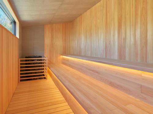a sauna with wood paneling and a row of wine racks at seven x seven Itoshima in Itoshima