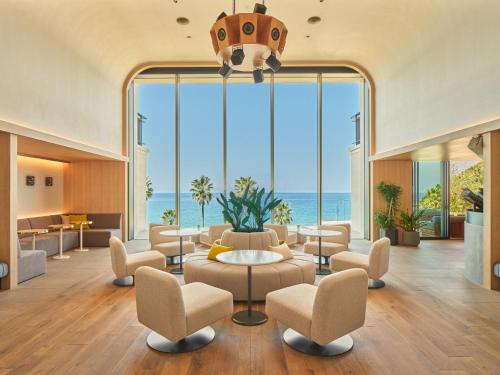 a living room with a large window with the ocean at seven x seven Itoshima in Itoshima
