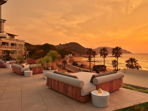 a resort patio with couches and a view of the ocean at seven x seven Itoshima in Itoshima