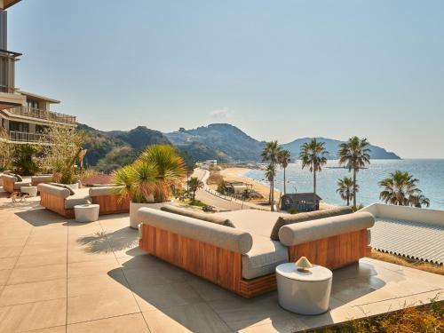 a resort patio with couches and a view of the ocean at seven x seven Itoshima in Itoshima