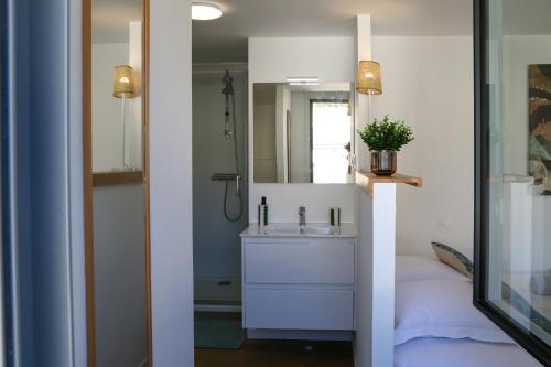 a bathroom with a sink and a mirror at Azur Cancale in Cancale