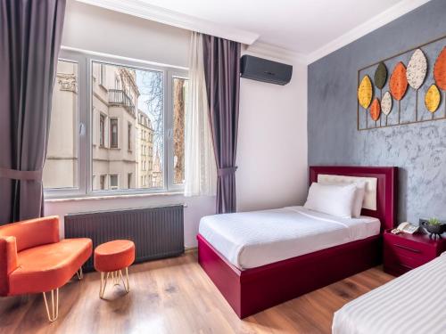 a hotel room with a bed and a chair at Perazre Hotel in Istanbul