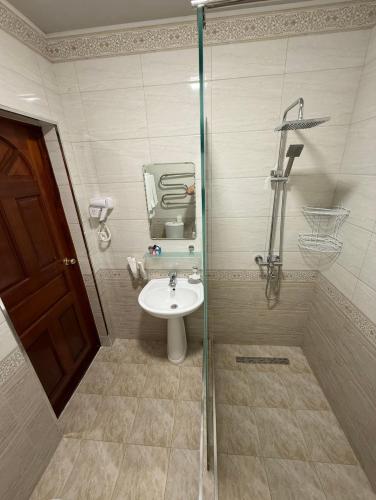 a bathroom with a sink and a glass shower at Hotel Asia Khiva in Khiva