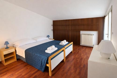 a bedroom with a bed with two towels on it at Attico Zamagna in Cesenatico