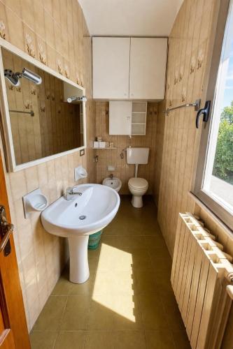 a bathroom with a sink and a toilet at Attico Zamagna in Cesenatico