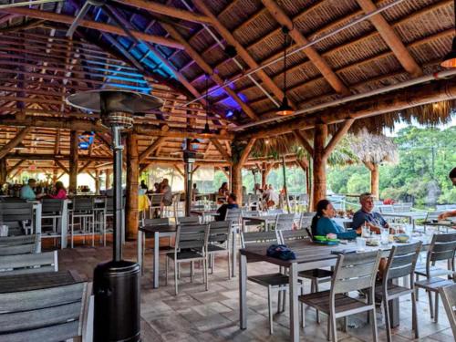 a group of people sitting at tables in a restaurant at Cape Crossing 104 in Merritt Island
