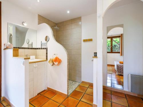 a kitchen with white walls and orange tile floors at chambres d'hôtes villa OZ in Bidart