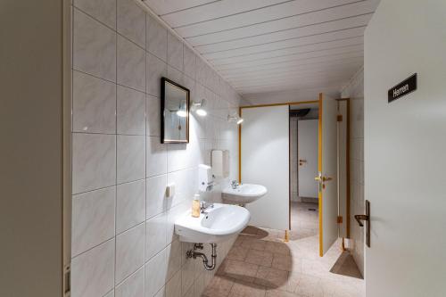 a bathroom with two sinks and a mirror at Monteurzimmer Jerichow in Jerichow