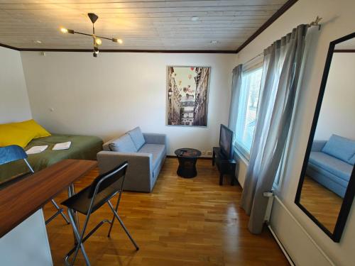 a small living room with a couch and a table at As 8 Viima inc Sauna in Valkeakoski