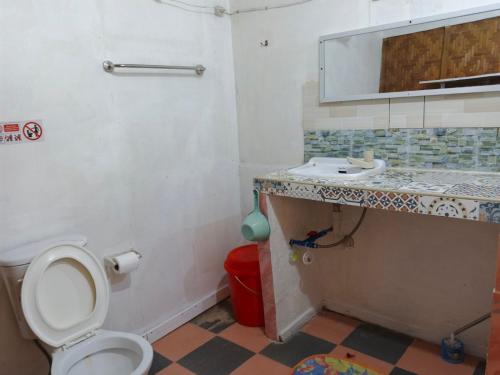 a bathroom with a toilet and a sink at Cronin Residences in Oslob
