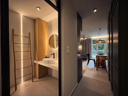 a bathroom with a sink and a hallway with a table at Central Luxury Sea View Apartment in Chalkida