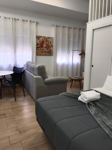 a living room with a couch and a table at RockSide Residences Suites La Línea VII in La Línea de la Concepción