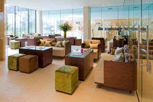 a lobby with couches and tables in a building at Ockenden Manor Hotel & Spa in Cuckfield