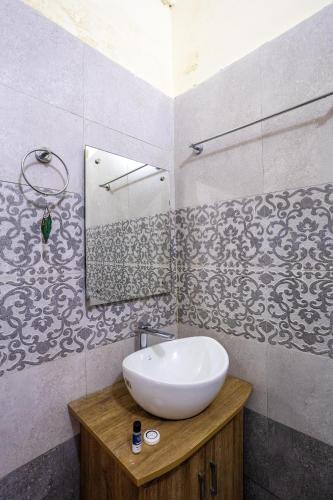 a bathroom with a sink and a mirror at By the Lakeside in Bhīm Tāl