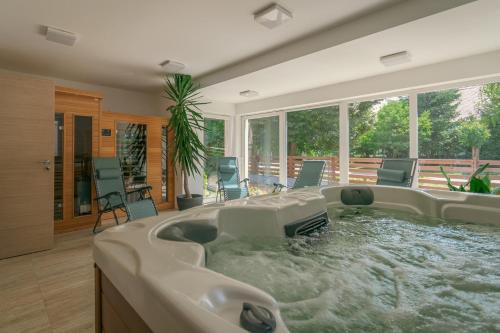 a jacuzzi tub in a living room at Rév-Panzió in Abádszalók