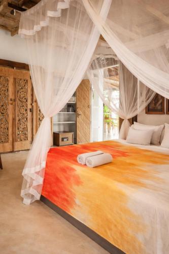 a bedroom with a large bed with a canopy at Deep Blue in Matara