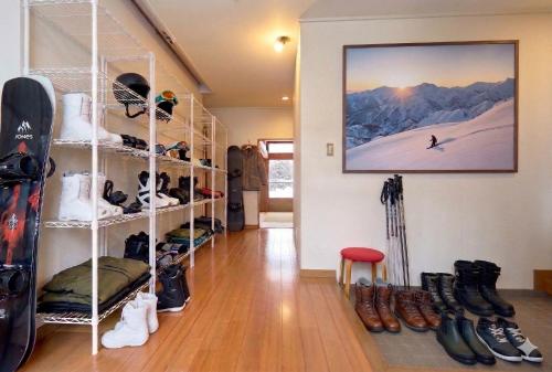 a room filled with lots of shoes and snowboards at Max 29 ppl, Entire building, near ski resort,16 beds, 4 futons ,Washer and dryer!! in Yuzawa