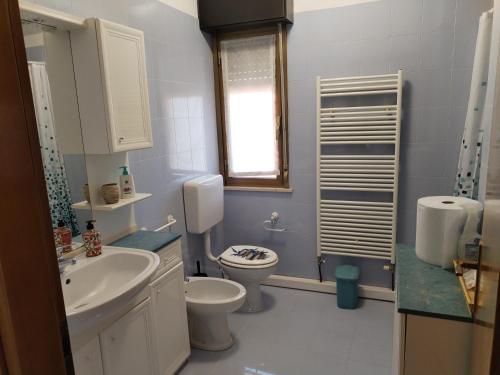 a bathroom with a toilet and a sink at home sweet home in Buia