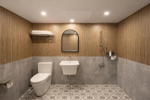 a bathroom with a toilet and a sink at Gangneung Wheel Hotel in Gangneung