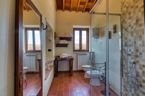 a bathroom with a shower and a toilet and a sink at La Casa Di Campagna in Magione