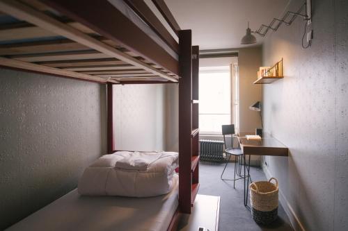 HO36 Hostel في ليون: غرفة نوم مع سرير بطابقين في غرفة
