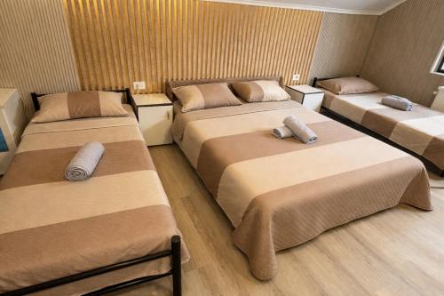 a room with three beds with pillows on them at Andya in Constanţa