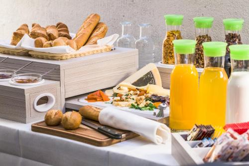 a table topped with lots of food and bottles of juice at Locanda al Vescovo & SPA in Verona