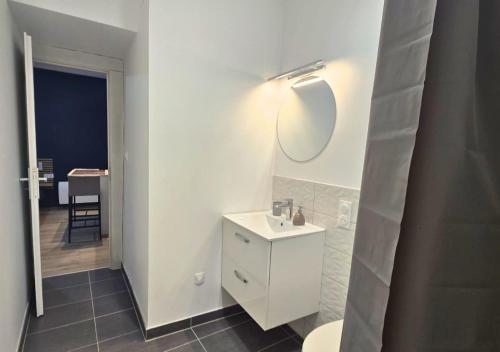 a white bathroom with a sink and a mirror at L'Evasion Zen au cœur de l'Alsace in Sélestat