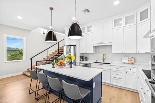 a kitchen with white cabinets and a blue island at 50 8th Avenue in Indialantic