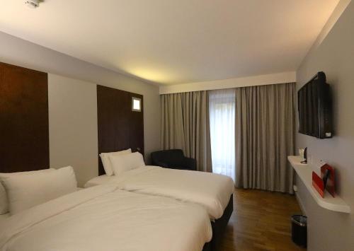a hotel room with two beds and a window at Park Inn by Radisson Birmingham Walsall in Walsall