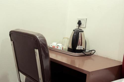 a desk with a coffee maker on top of it at Hotel Panchvati in Durgāpur