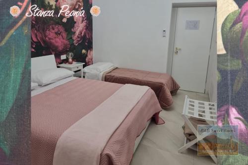 a bedroom with two beds and a chair in it at B&B Sweet Ruins in Ercolano