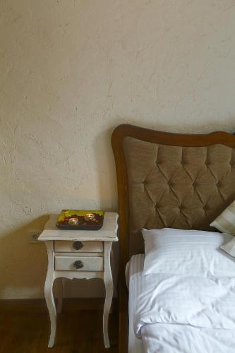 a bed with a night stand next to a side table at Ibri Hotel in Selcuk