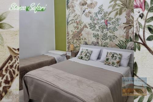 a bedroom with two beds and a mural of a giraffe at B&B Sweet Ruins in Ercolano
