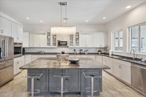 a large kitchen with white cabinets and a large island at 51 N Orlando Ave in Cocoa Beach