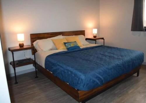 a bedroom with a large bed with two night stands at Rivers Edge Lofts - Unit 9 in Niles