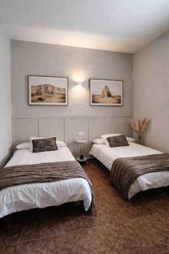 two beds in a hotel room with two bedsvisor at Hernani Bardenas in Arguedas
