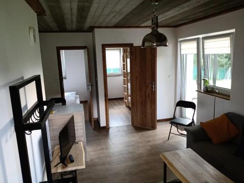 a living room with a couch and a table at Apartamenty Siedlisko in Ostre