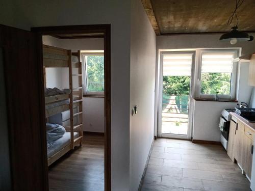 a room with a door open to a room with a kitchen at Apartamenty Siedlisko in Ostre