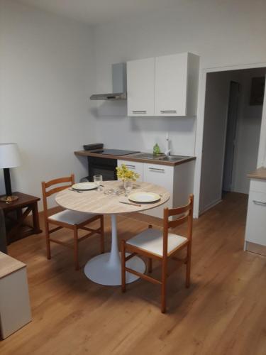 a kitchen with a table and chairs in a kitchen at les ruffins in Saint-Jean-en-Royans