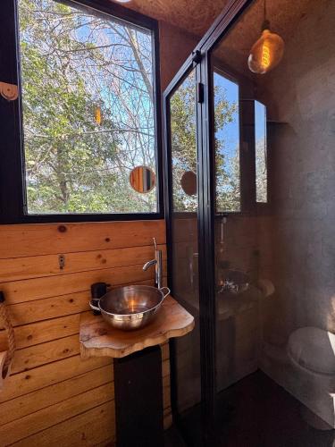 a bathroom with a bowl sink and a shower at MONKEY MANSION - Luxury Treehouse - Private Escape with outdoor hot Tub in Abū Mīzān