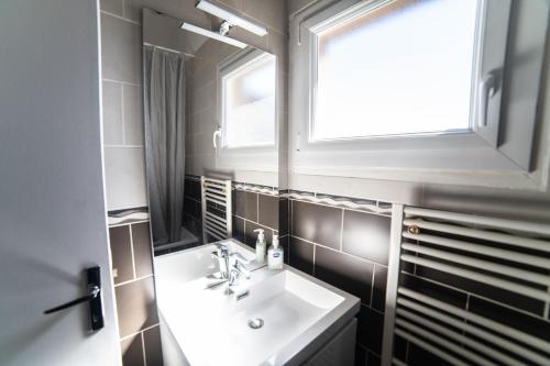 a bathroom with a sink and a window at Le Donjon - Agréable T2 centre ville - parking gratuit 2 min - in Mont-de-Marsan